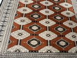 a close up of a brown and white rug on a wooden floor