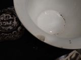 a white bowl sitting on top of a table next to a bowl
