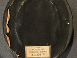 a black plate with a label on it on a table