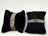 pair of black velvet pillows with gold and blue beads