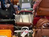 a lot of purses on the table in the store