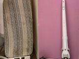 two vacuums that are sitting next to a ironing board