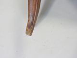 a close up of a chair with a wooden seat