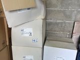 many boxes stacked on top of each other in a room