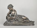 statue of a woman sitting on a rock with her hands on her face