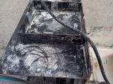 a broken toaster sitting on top of a box on the floor