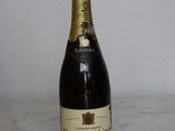 a bottle of champagne sitting on a marble table