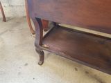 a wooden table with a shelf on top of it
