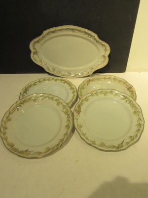 four plates are sitting on a table in front of a black wall