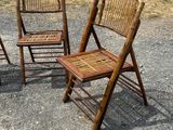 three chairs that are sitting in the gravel