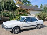 une voiture blanche garée devant une maison