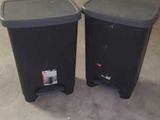two trash cans that are sitting on the floor