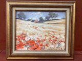 une peinture à l'huile d'un champ de coquelicots rouges dans un cadre doré