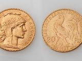 a gold coin with a woman ' s head and a bird on it