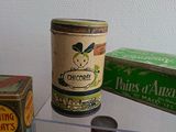 many different types of tins on display in a glass case