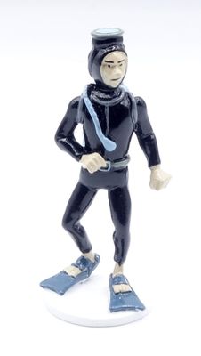 a figurine of a man in a wet suit and diving gear