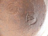 a close up of a brown vase with a bird on it