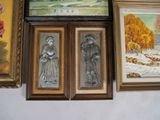 three framed pictures on the wall of a room