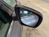 a side view mirror of a car on the side of the road