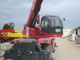a red crane that is sitting on the side of the road