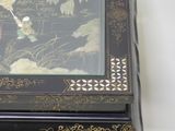 a black and gold box with a picture of a bird on it
