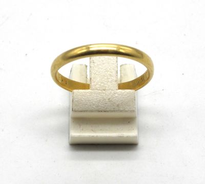 a close up of a gold ring on a white surface