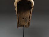 an image of a wooden helmet on a stand on a white surface