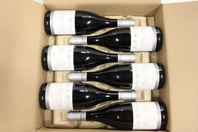 six bottles of wine in a box on the table