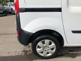 a small white van parked in a parking lot
