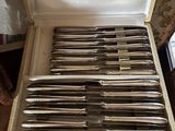a lot of silverware in a box on a table
