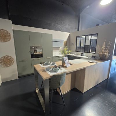 a kitchen with a table and chairs in the middle of the room