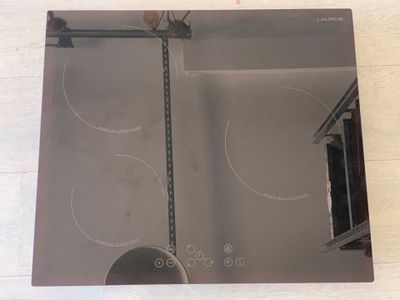 a picture of a kitchen with a glass stove top
