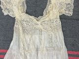 an image of a white dress with lace on the shoulders
