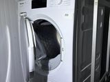 an image of a washer and dryer in a small room