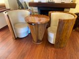 two chairs and a table in a room with wood floors