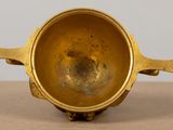 a gold cup that is sitting on a table
