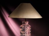 a lamp that is sitting on a table with a shade on it
