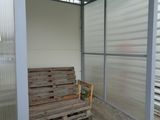 a wooden bench in the corner of a building