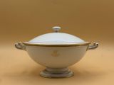 an image of a white and gold bowl with a lid