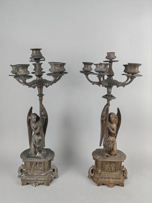pair of antique bronze candlesticks with angels and angels on them