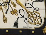 a black and gold scarf with a bunch of keys on it