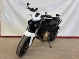 a black and white motorcycle parked in a garage