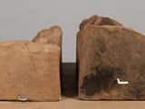 pair of wooden bookends sitting on top of a wooden table