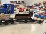 many toy cars on a table with a train on it