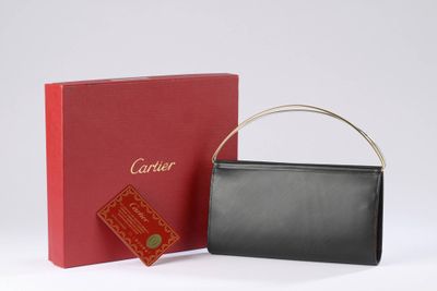 a black and red purse next to a red box on a white surface