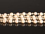 pearls are arranged in a row on a black surface