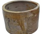 a brown pot that is sitting on a white surface