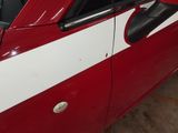 a red and white car parked in a garage