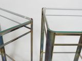 pair of brass and glass side tables with a clear glass top
