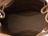 the inside of a brown purse with a zipper on the inside